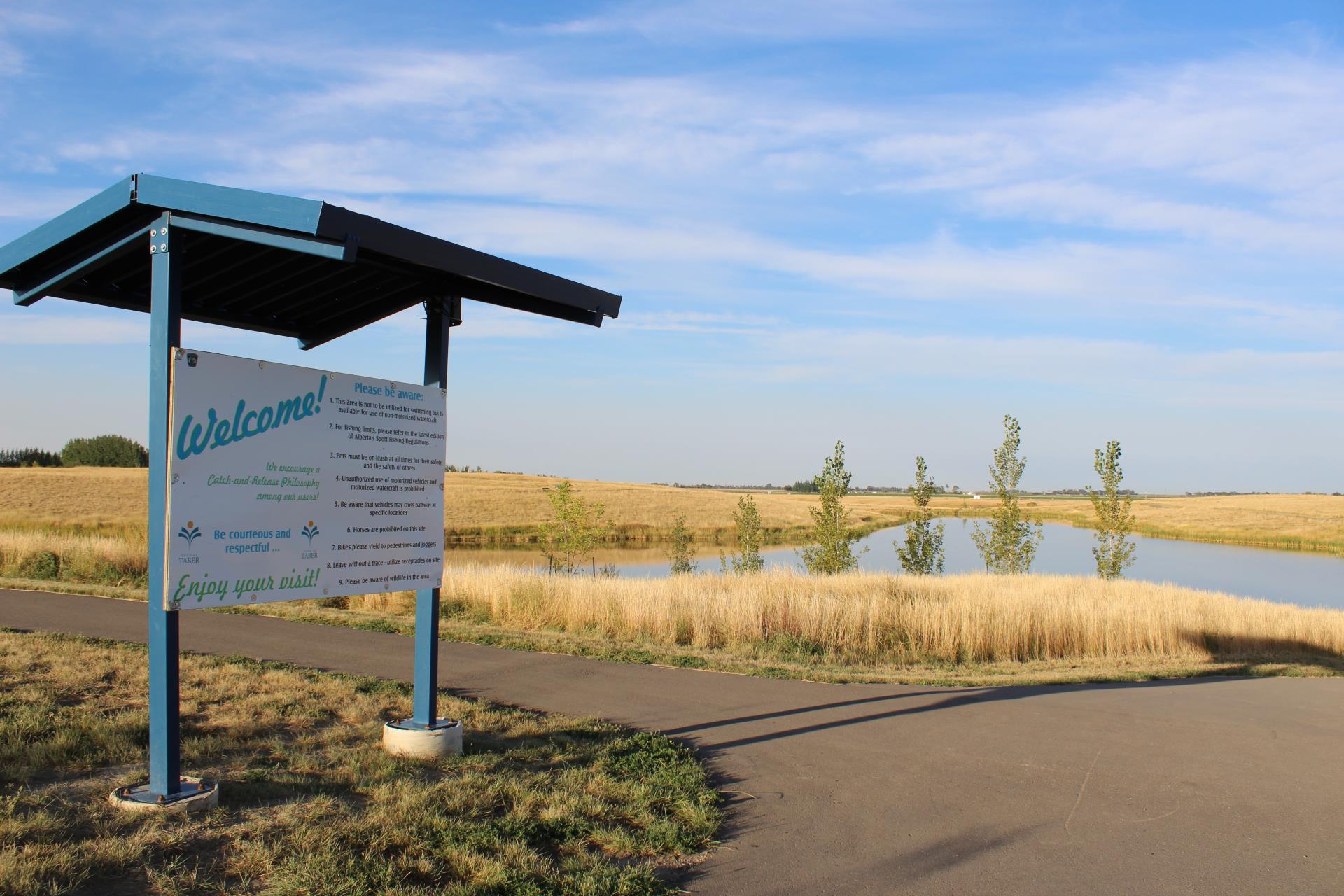 Trout Pond Welcome Sign and Paved Trail